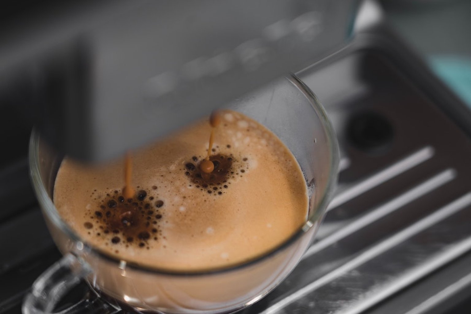 Fresh Dallmayr Capsa coffee flowing from a capsule machine into a cup