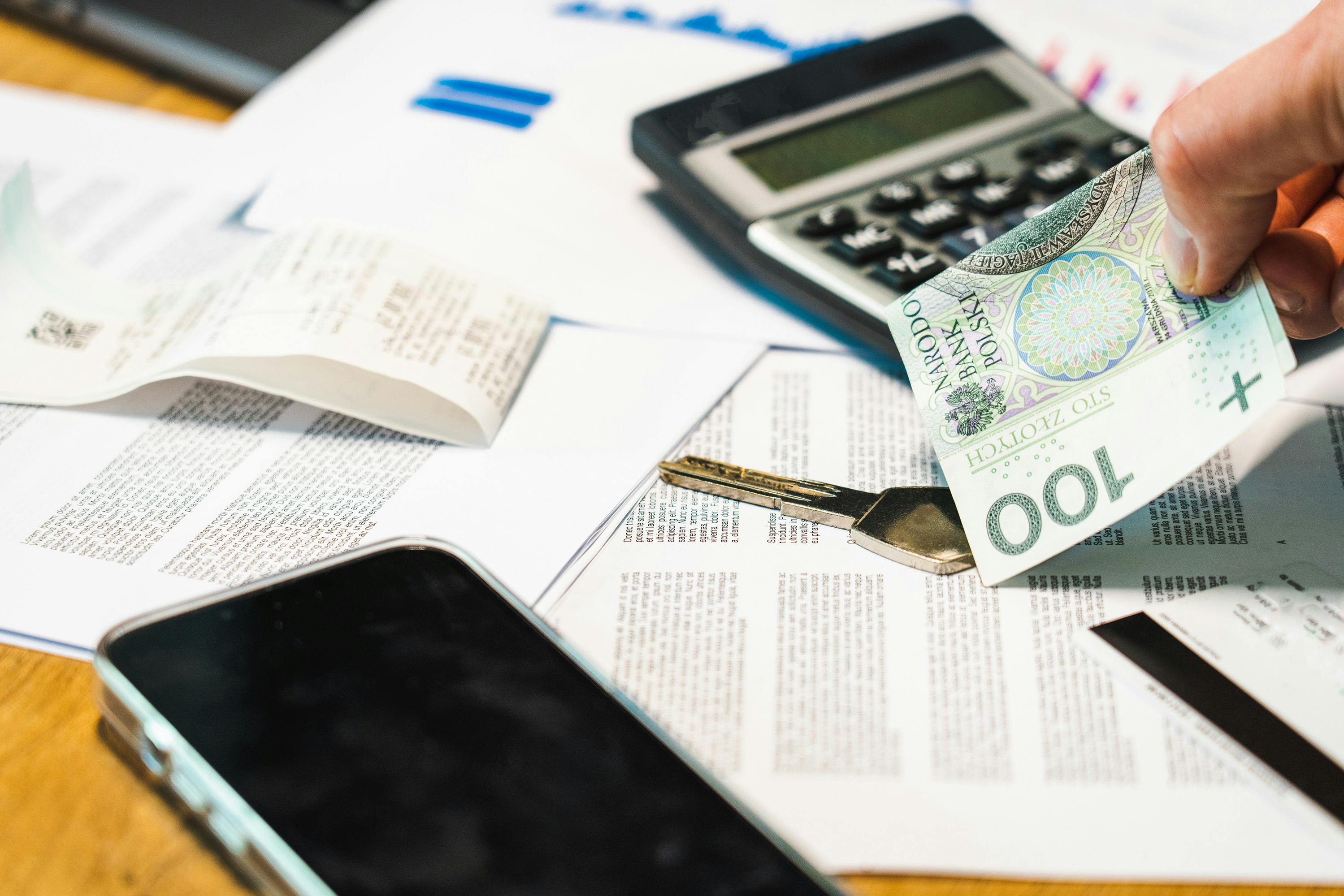 HVAC business owner reviewing invoices and cash flow reports at office desk