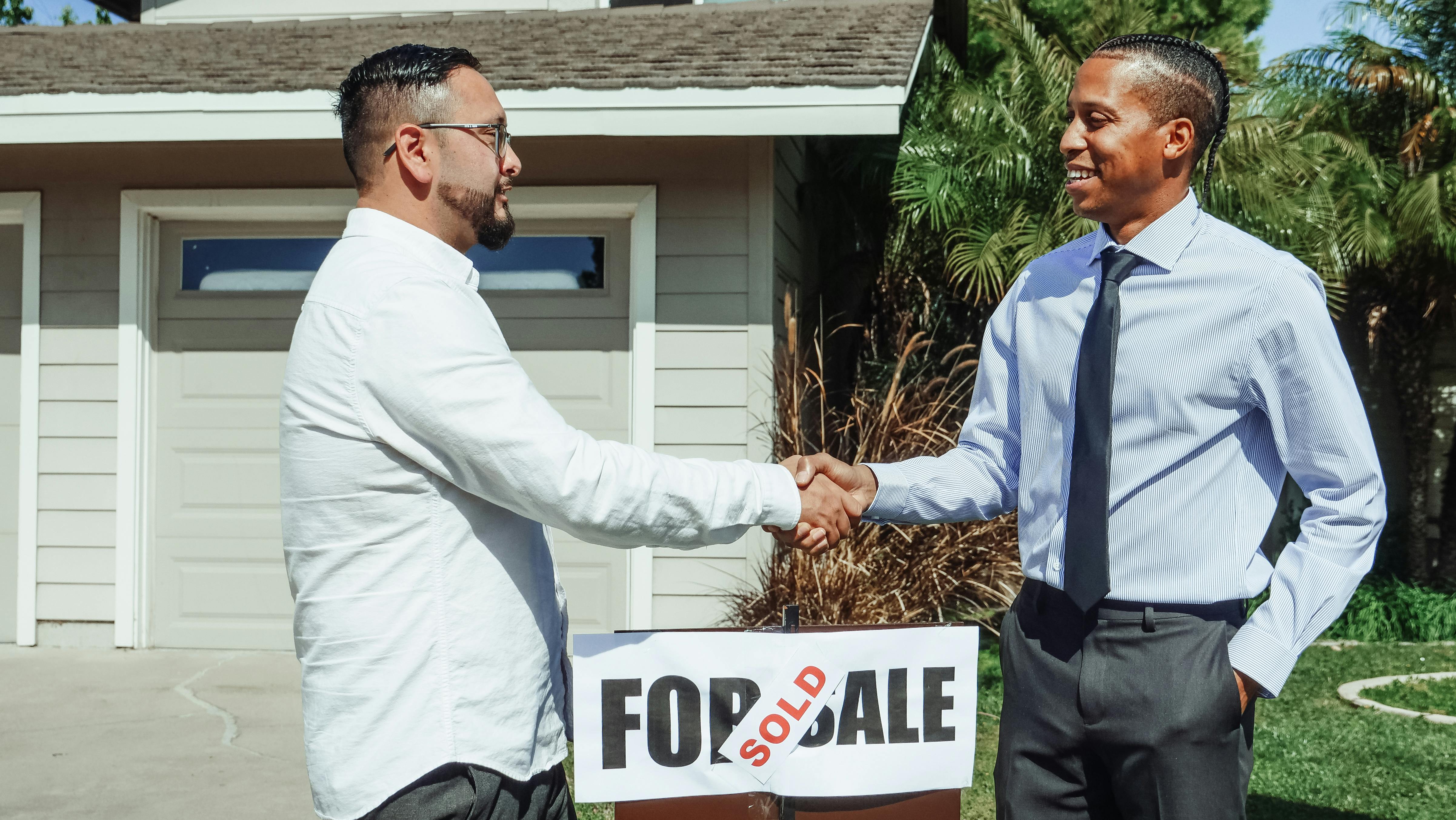 HVAC sales representative explaining service agreement options to a customer on a digital tablet during a home visit