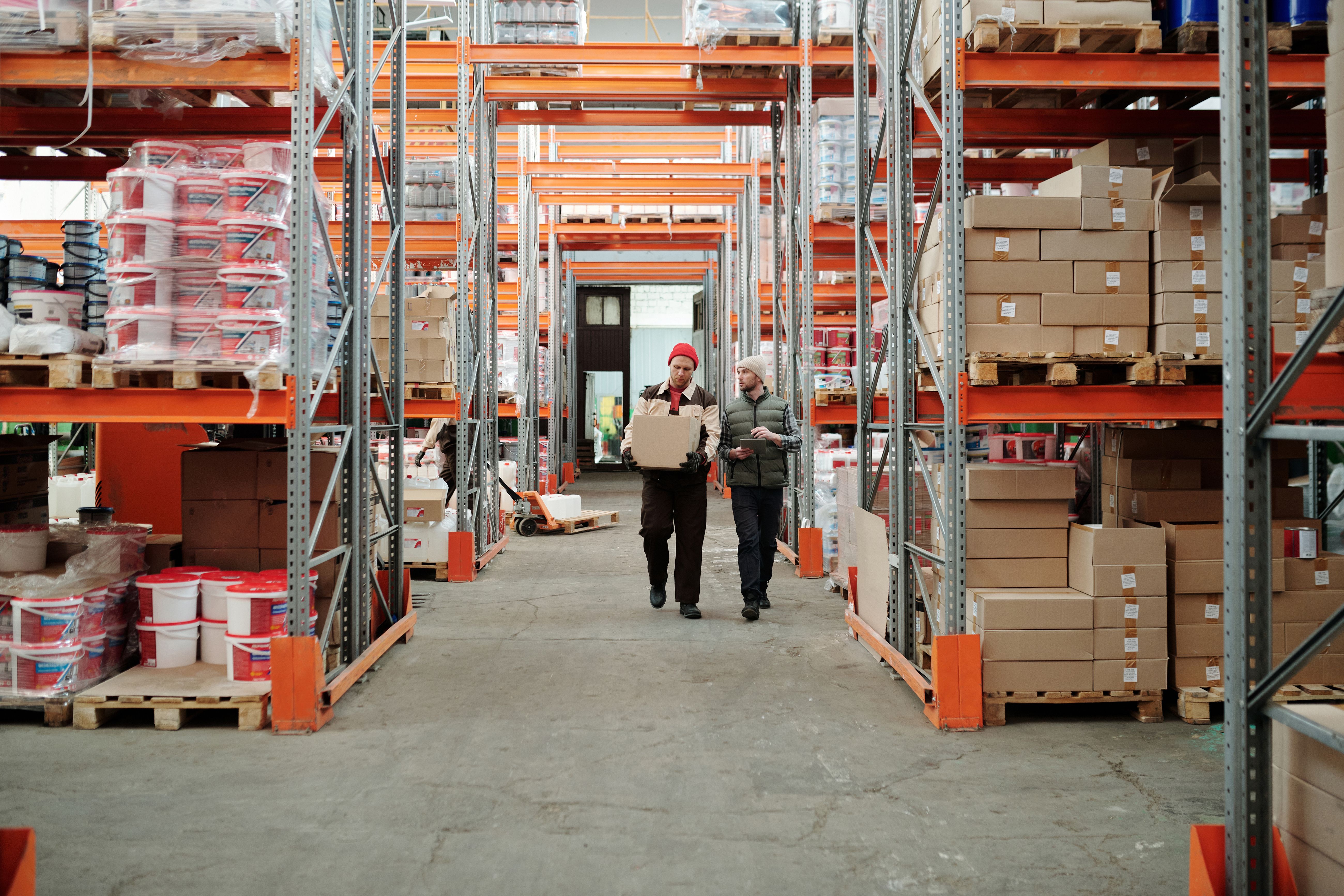 HVAC technician checking inventory stock and parts in warehouse using digital system