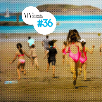 Children in swimsuits run towards the ocean on a sandy beach, under a clear sky, with an island visible in the background.
