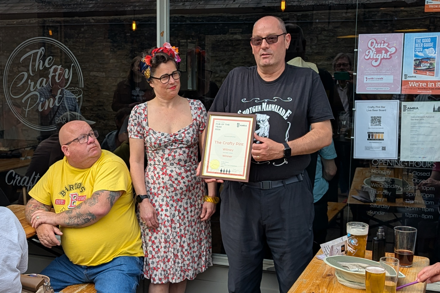 Mel outside The Crafty Pint receiving an award for best bar