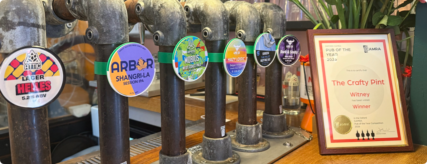 6 beer taps and a CAMRA award winner certificate on a bar