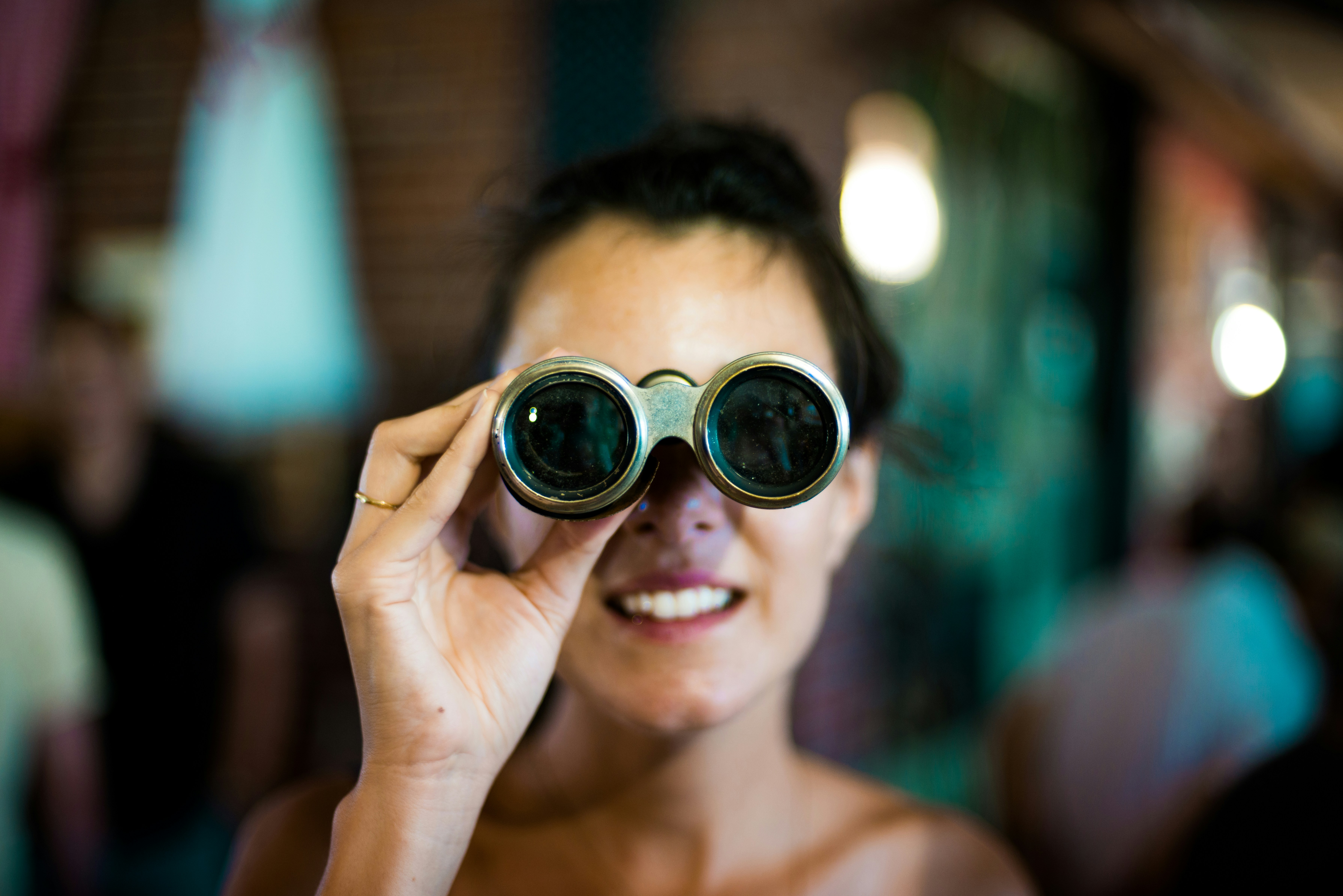 a woman looking through binoculars 