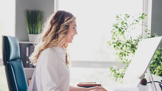 HR Manager sitting in her desk and working on her computer