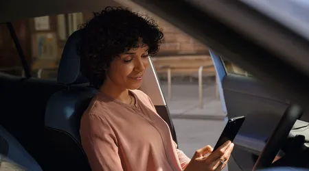 A woman in a car using an app