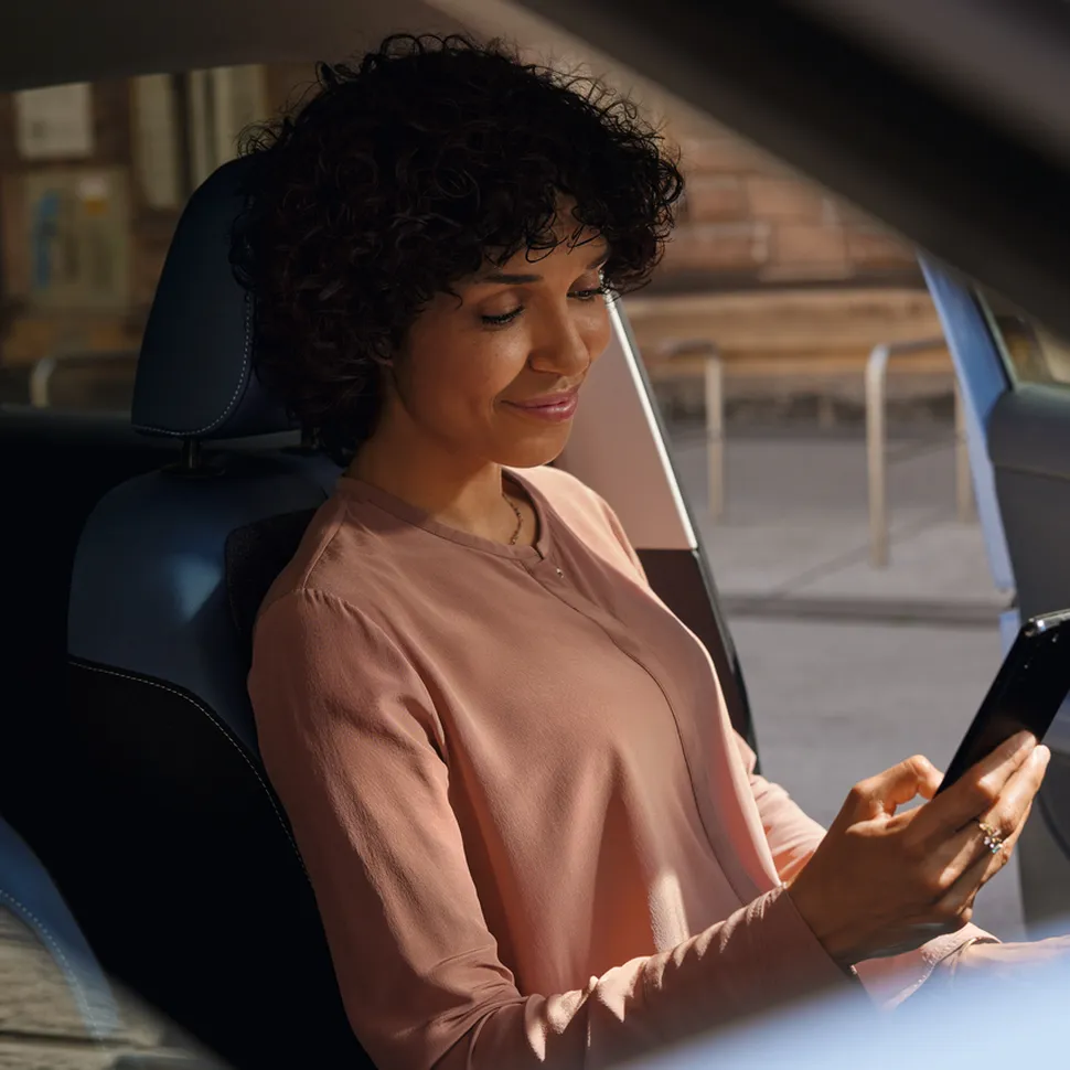 A woman in a car using an app
