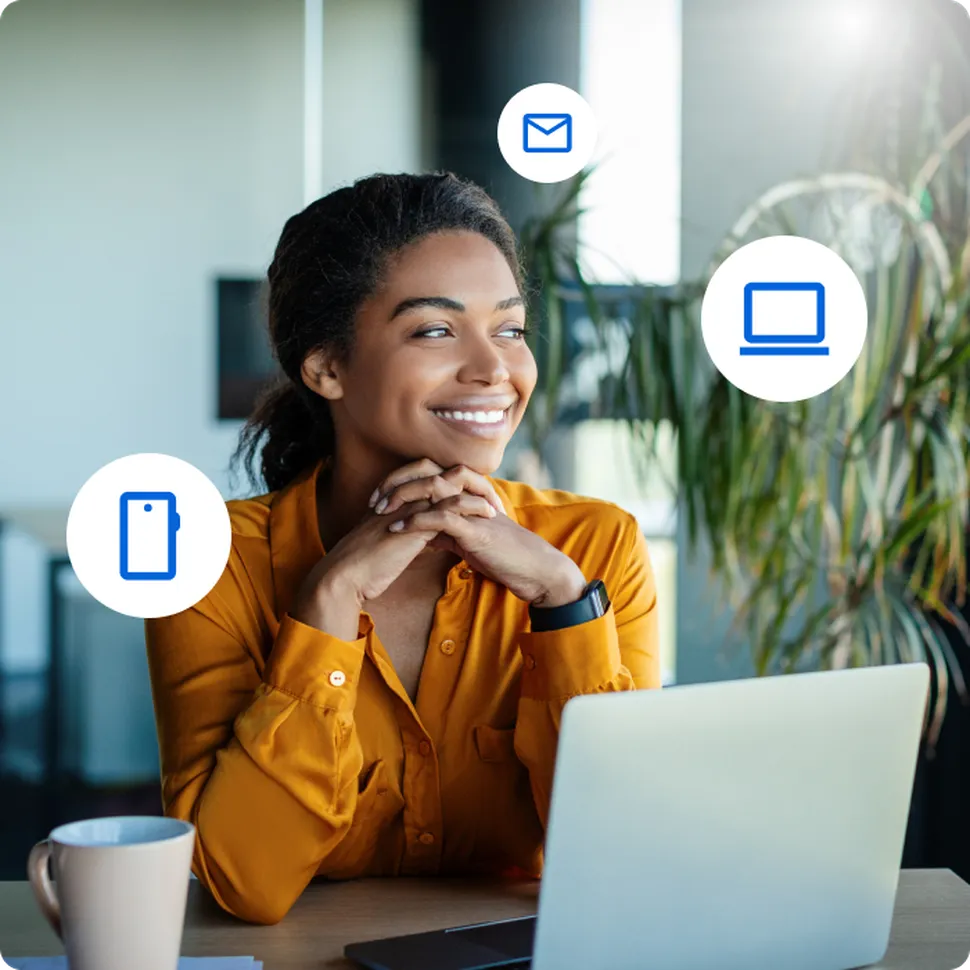 A woman sitting in fron of a computer with a coffe thinking about different channels of distribution for surveys