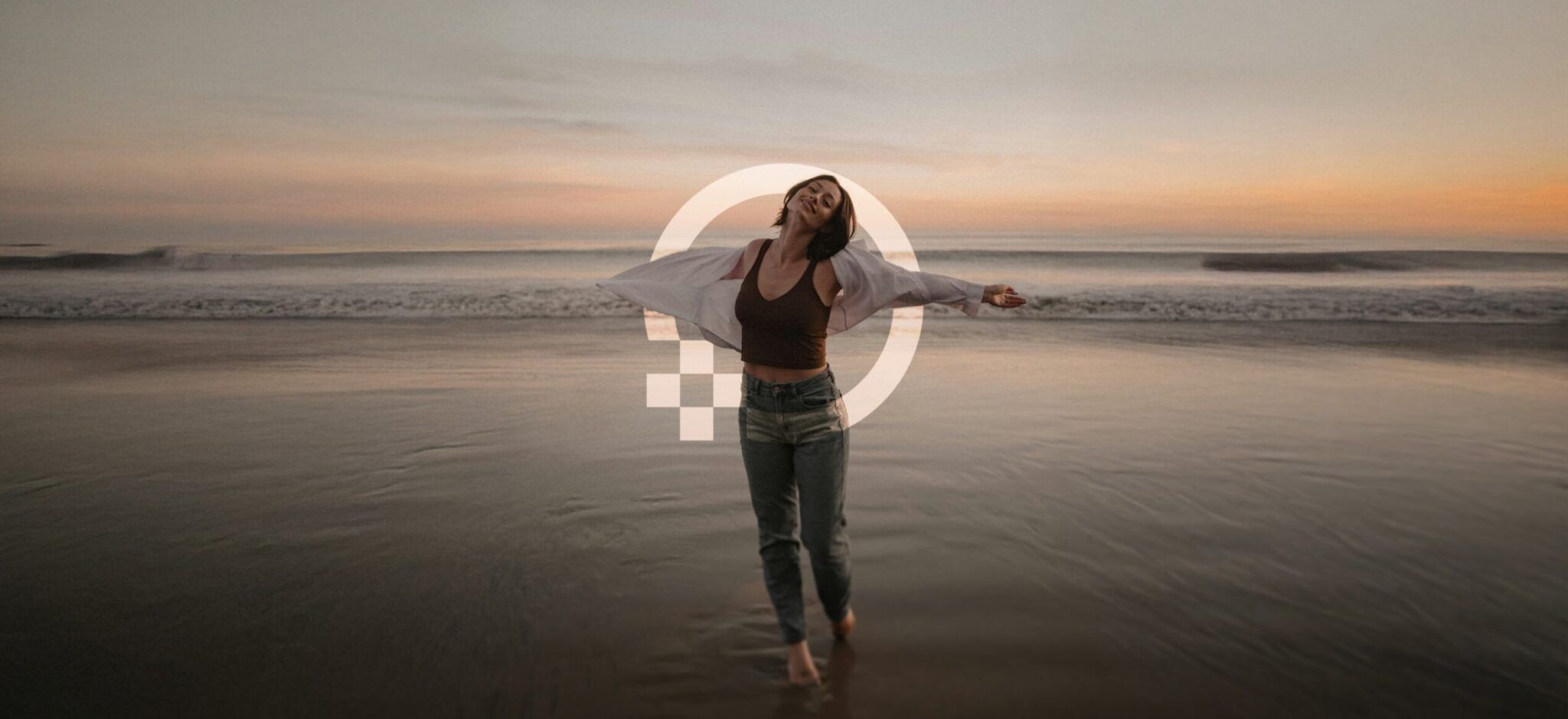 Woman spreading her arms in total freedm at a beach, surrounded by OneHealth Plus logo