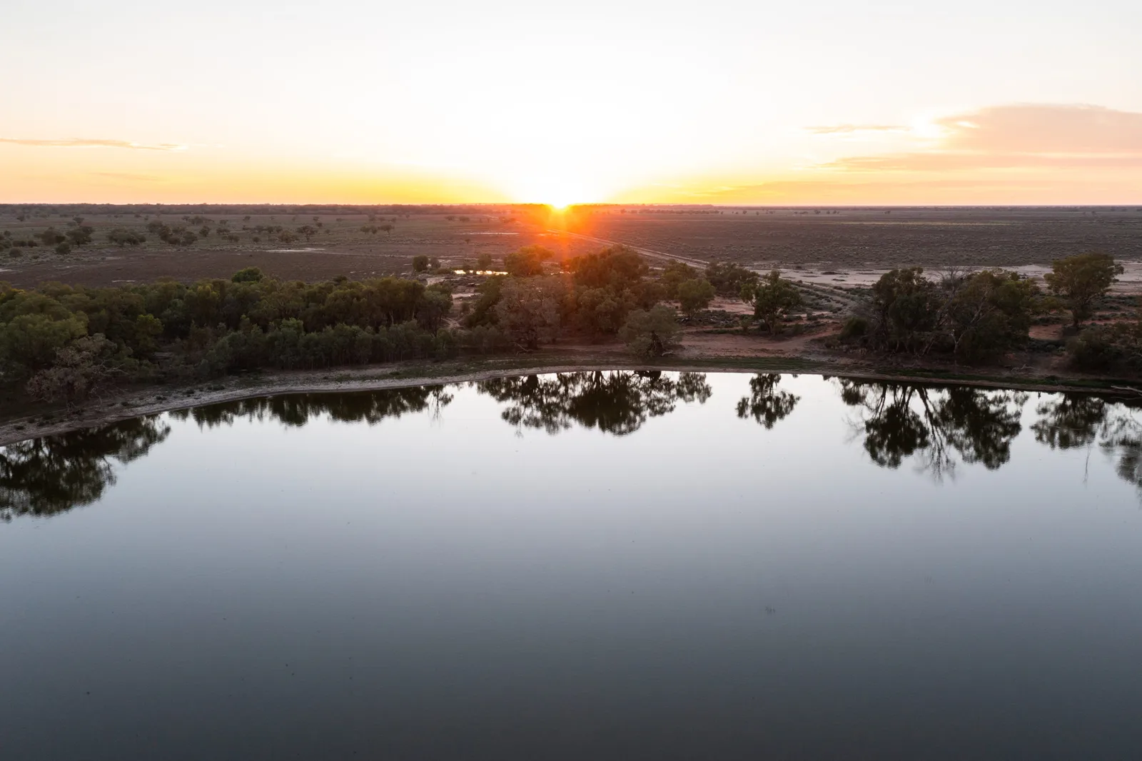 Sunrise over a lagoon fed by the Darling/Baaka River, three kilometres south-east of Wilcannia, North Western New South Wales, Wednesday, January 24, 2024. (AAP Image/Stuart Walmsley)