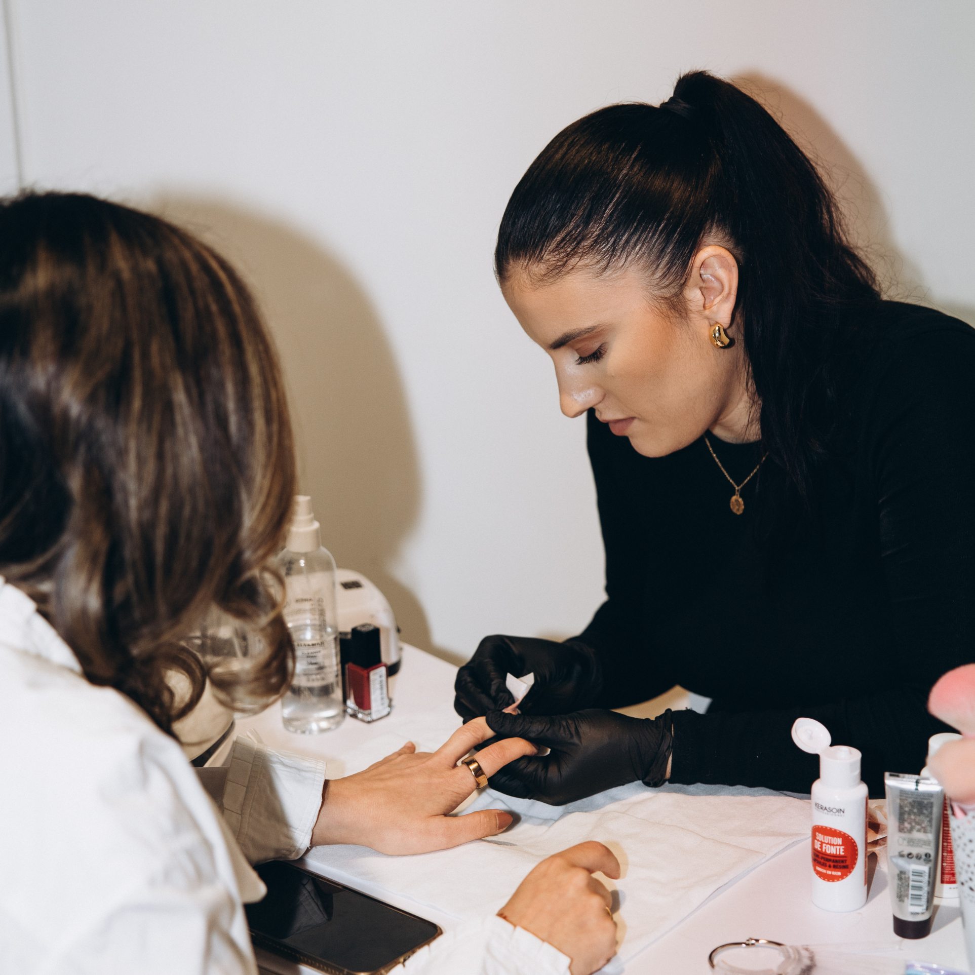 Ruuby nail technician performing a manicure on a client during an at-home appointment