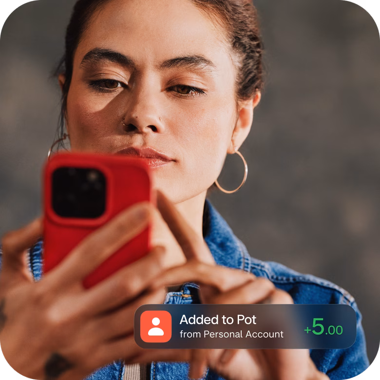 Person checking their phone with an interest notification on screen.