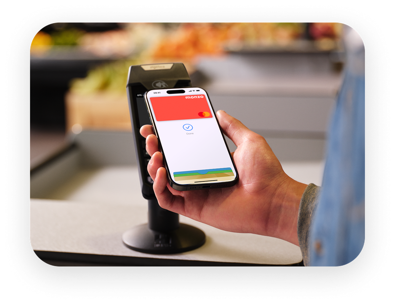 Person paying with their Monzo card with Apple Pay. 