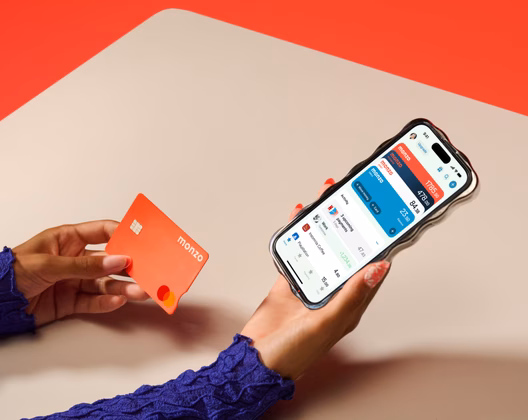 Person on phone holding hot coral card