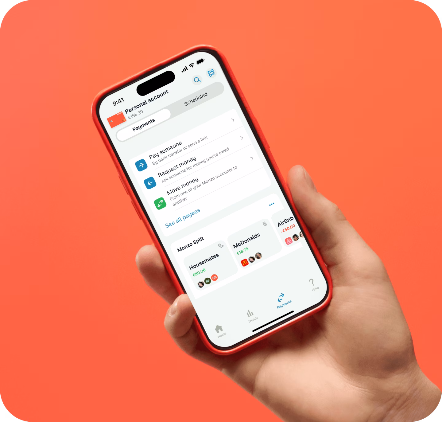 Hand holding phone on hot coral background with Payments UI. 