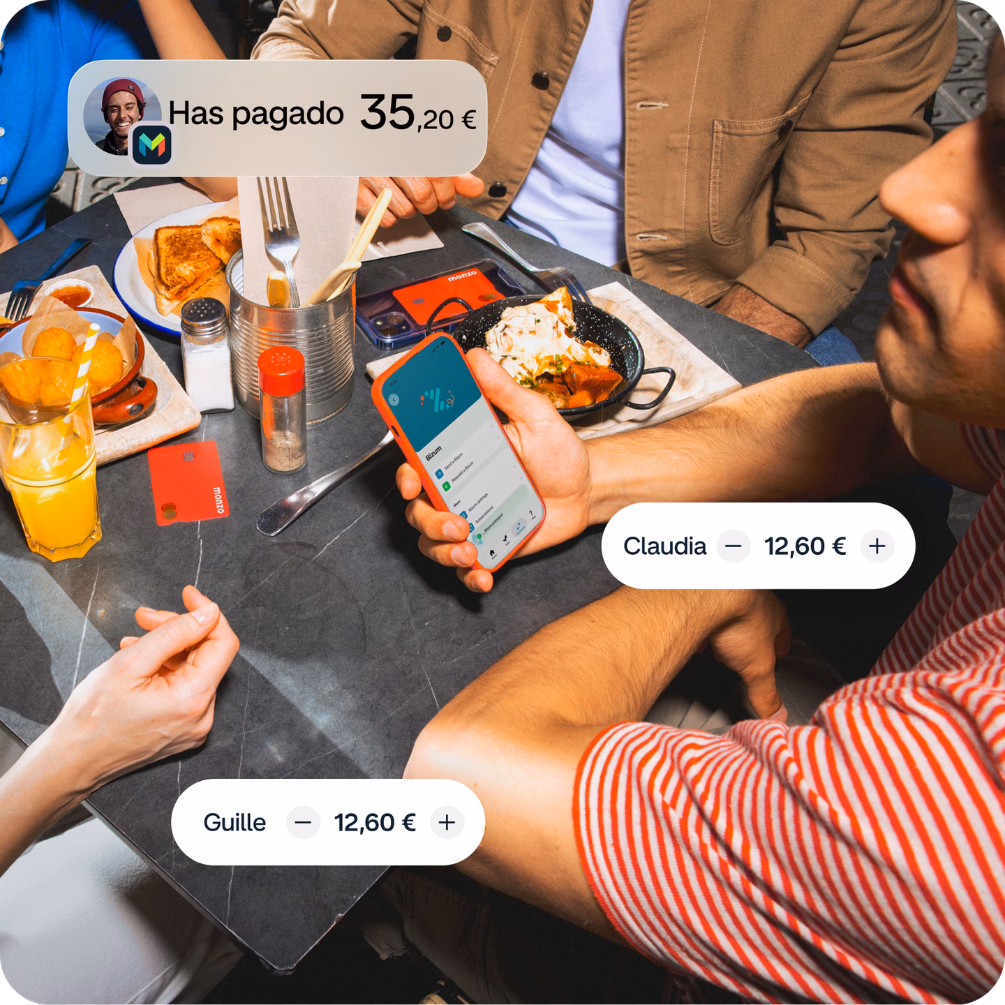 Grupo de amigos compartiendo una comida mientras dividen la cuenta con Monzo y Bizum.