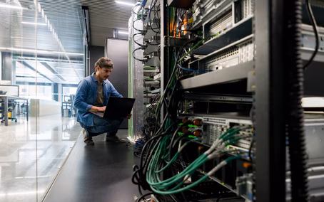 Computer technician repairing a network server in the office
