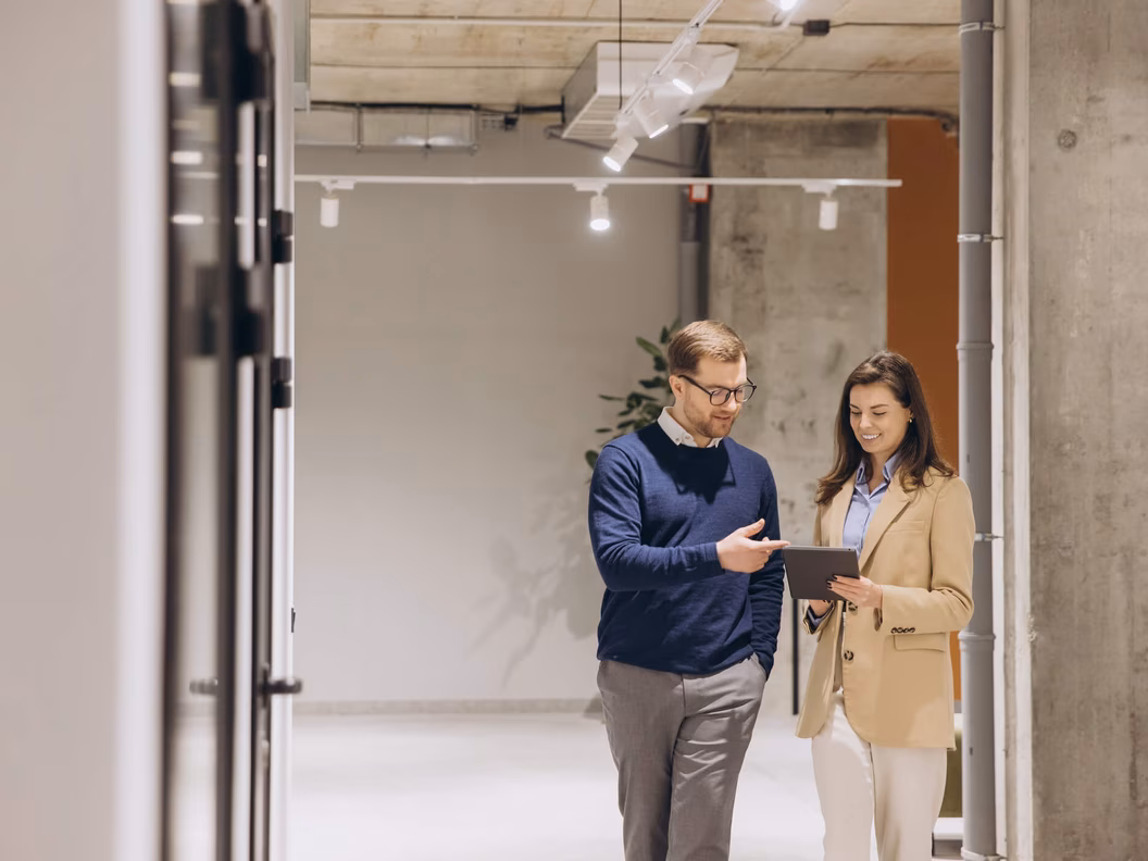 Two employees working together in a modern cloud infrastructure