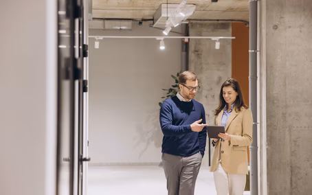 Two employees working together in a modern cloud infrastructure