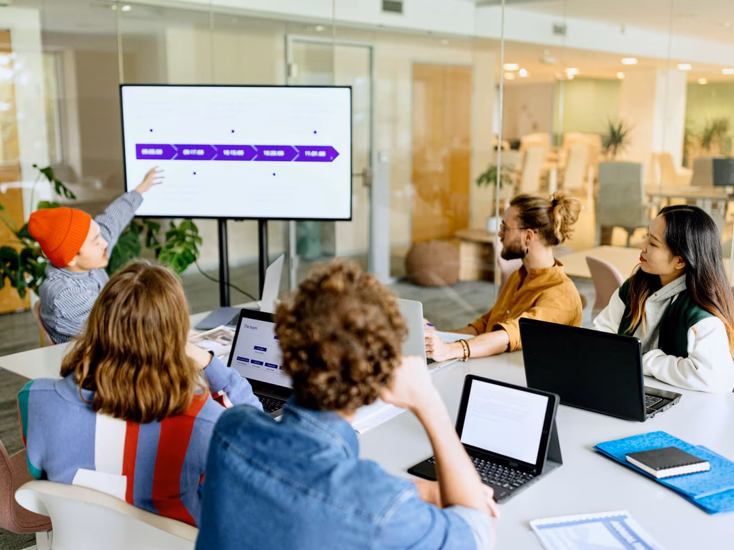 Diverse team discussing strategy in a modern glass meeting room