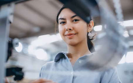 Portrait of a smiling young female employee in the IT workshop