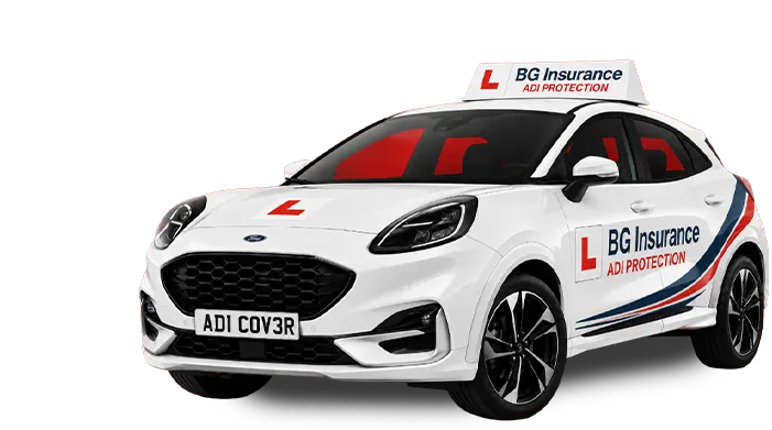 White Ford driving school car with L plates and BG Insurance ADI Protection branding on sides and roof sign.