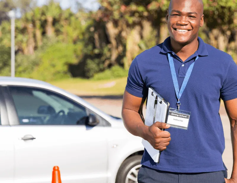 Female driving instructor giving thumbs up