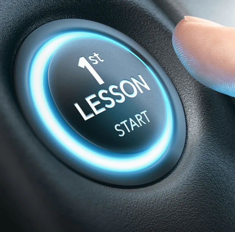 A finger pressing a glowing blue button labeled "1st Lesson Start" on a dark surface, symbolizing the beginning of learning.