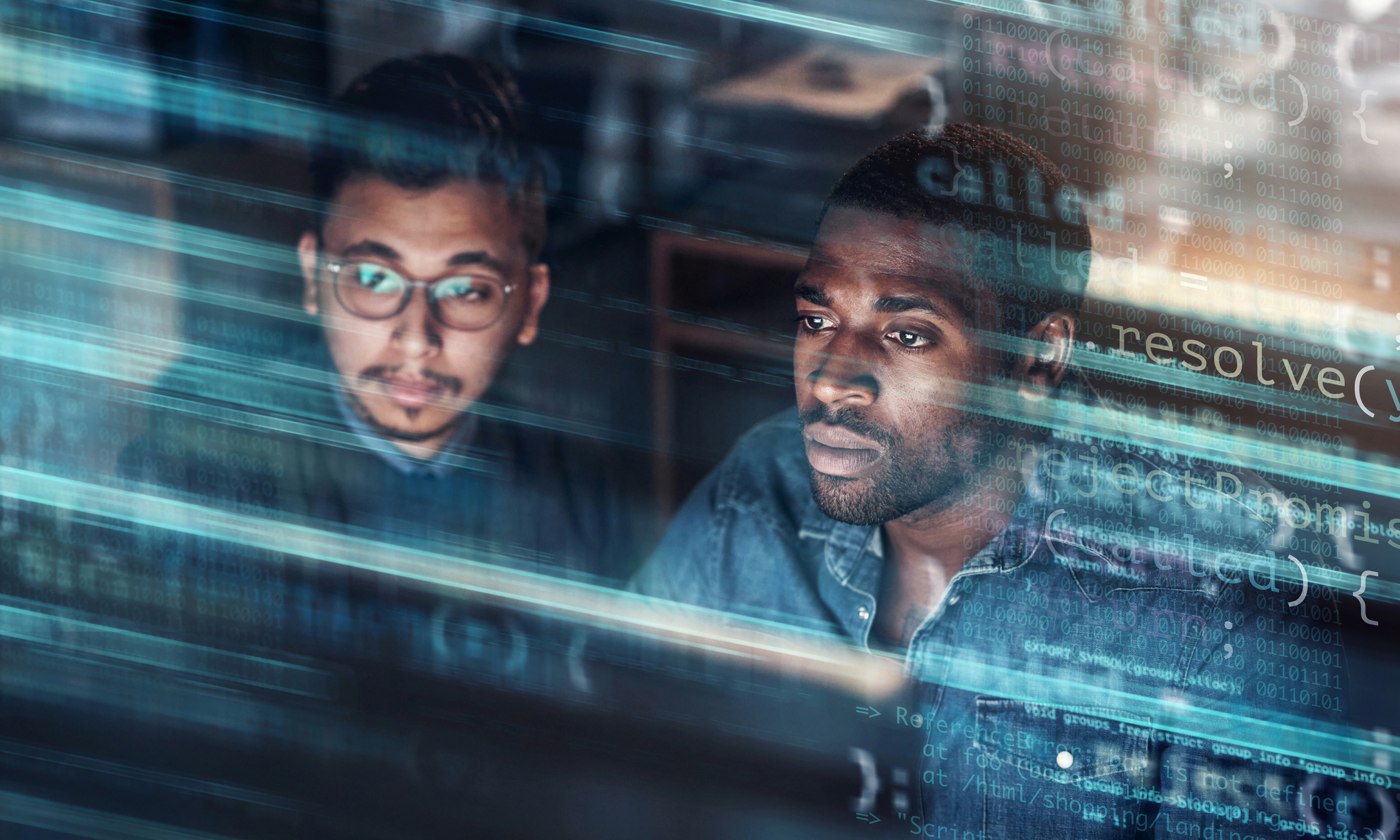 Two focused individuals working on computers, overlaid with transparent code and digital graphics, suggesting programming or software development.