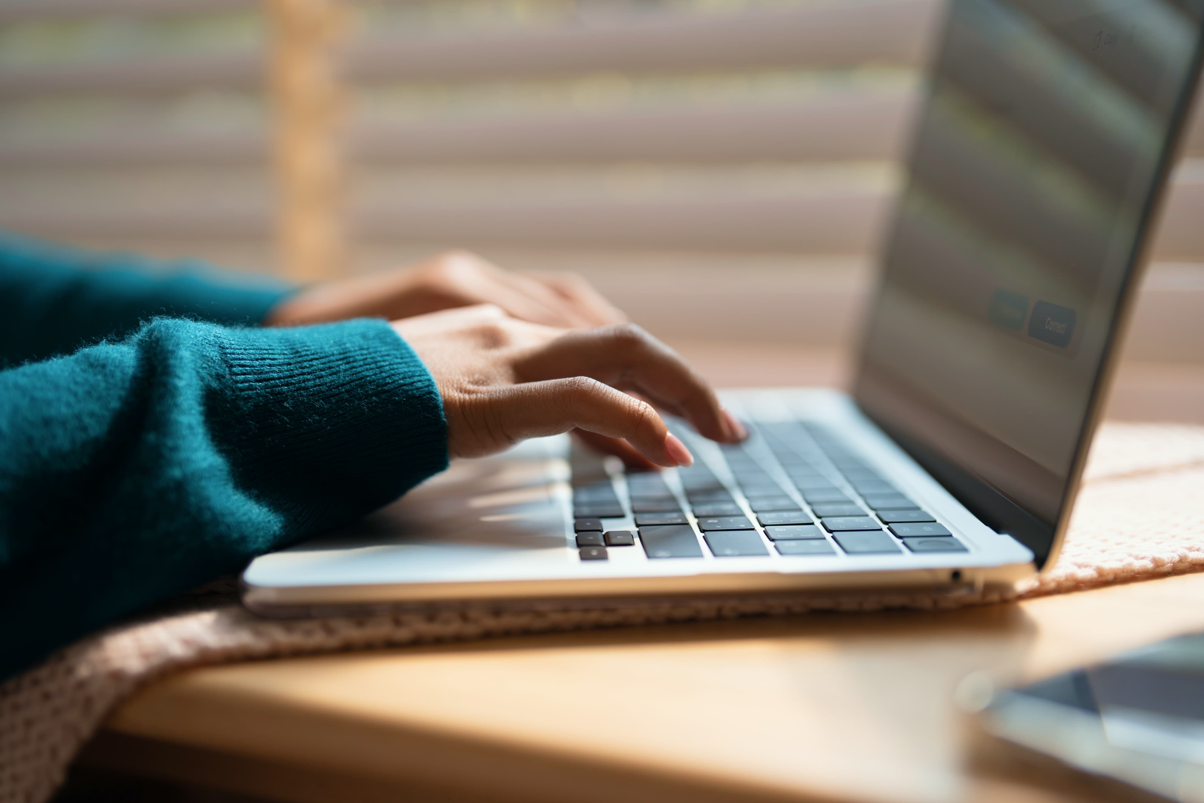 someone typing on a laptop