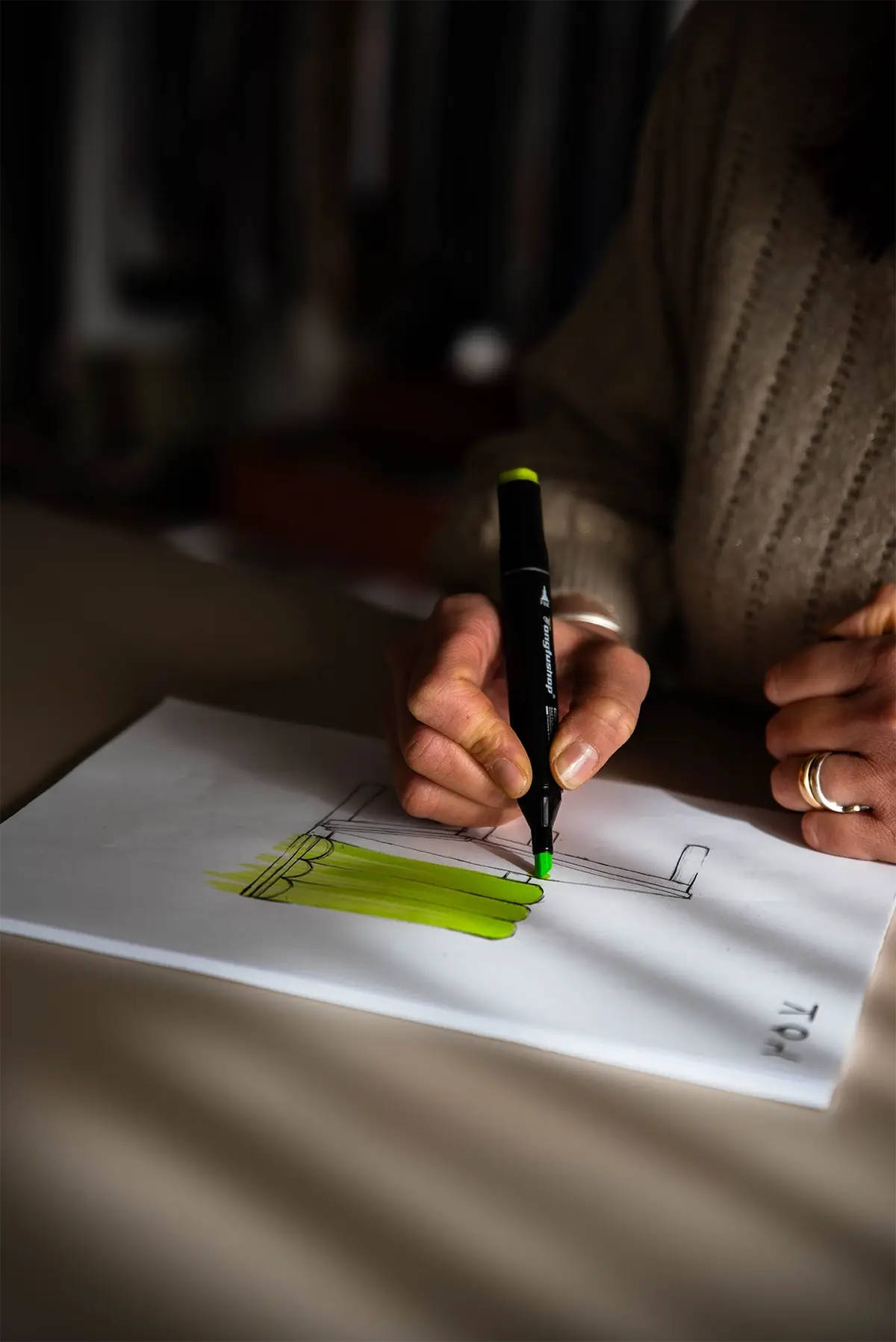 A designer working on a hand-drawn chair design