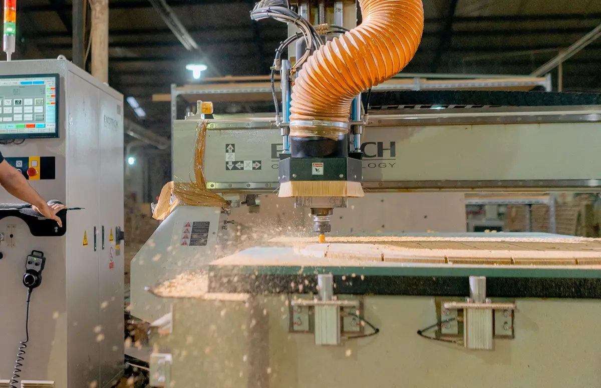 A CNC machine shaping timber in the furniture factory