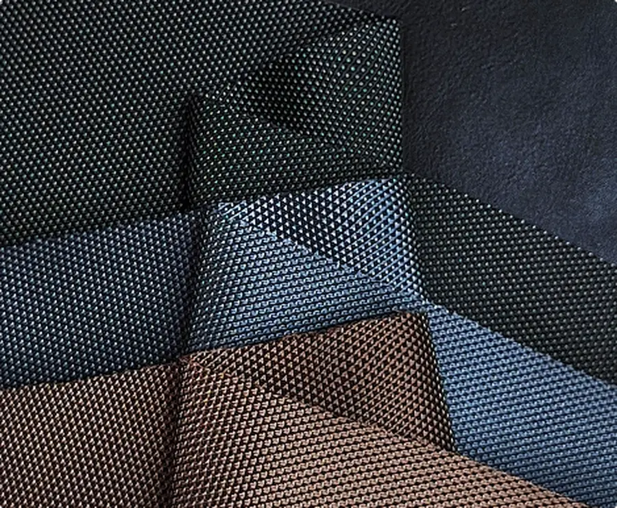 Layered upholstery fabric samples in blue, black and brown