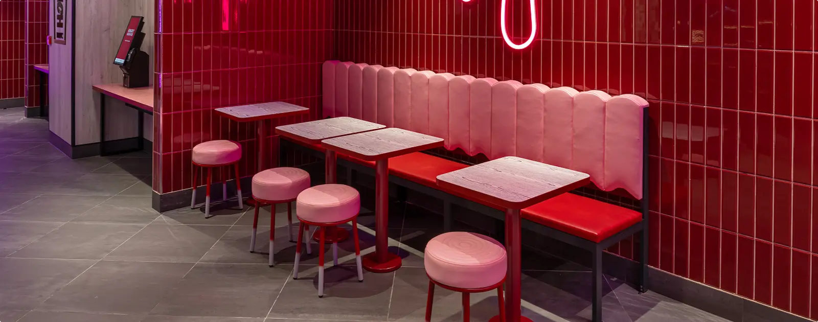 Restaurant interior with pink upholstered seating