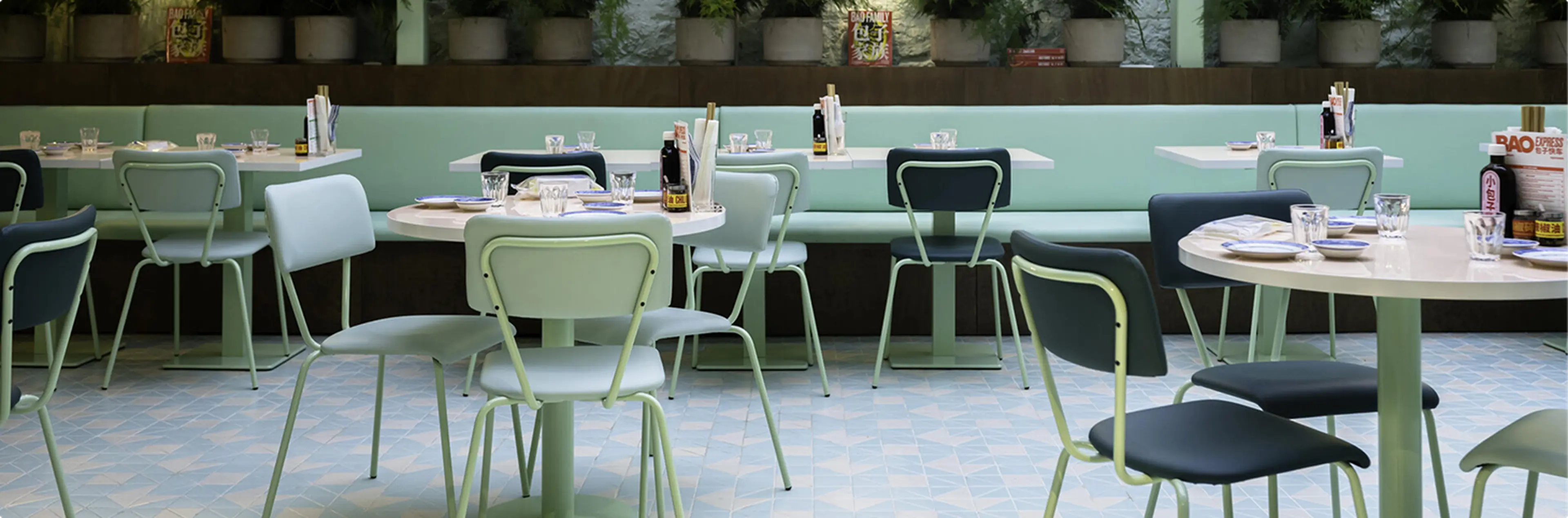 Cafe interior with green dining chairs and tables