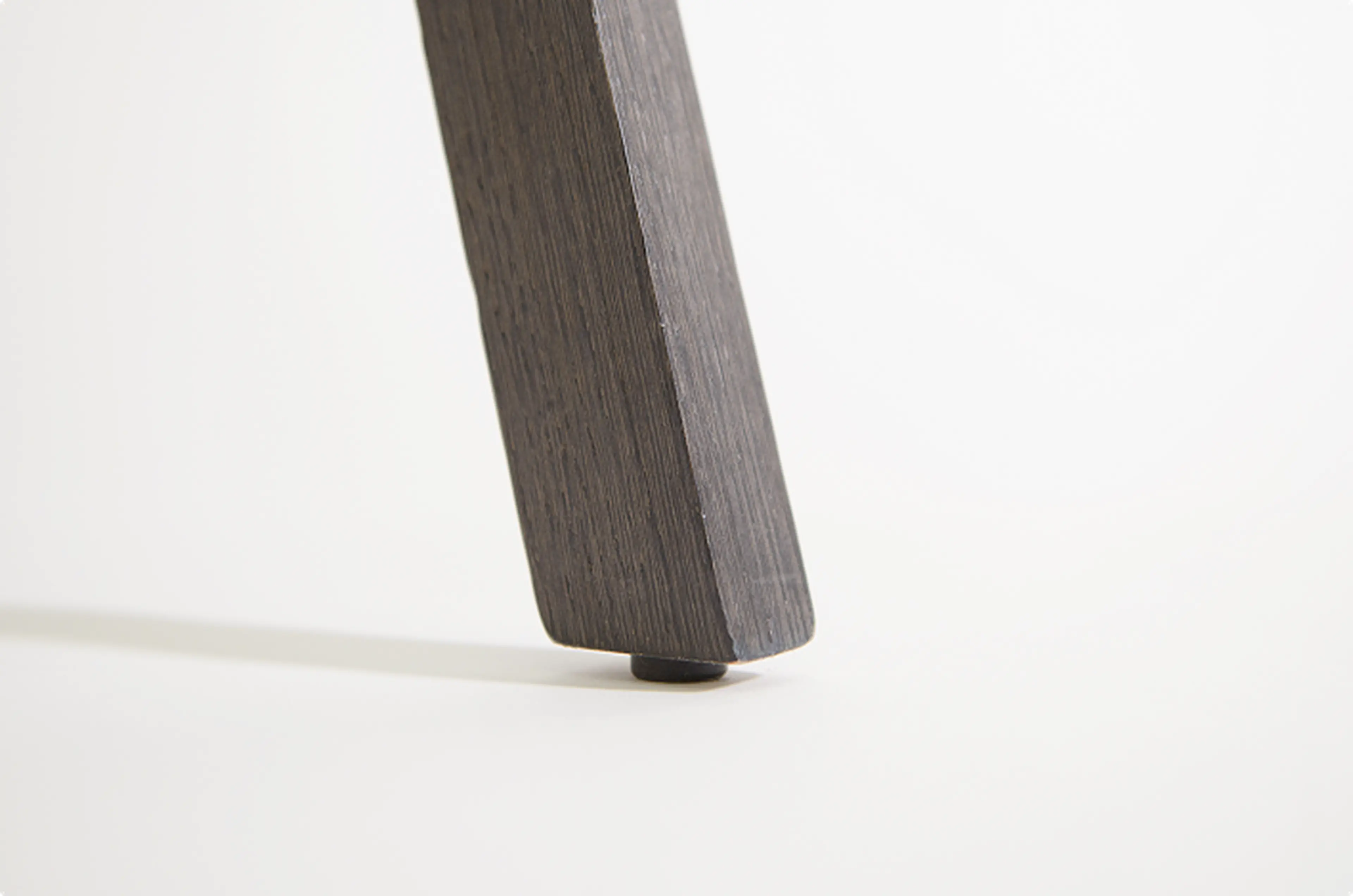 Protective glider beneath a timber chair leg