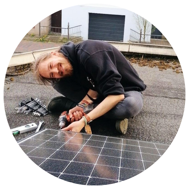 Foto von Mensch vor eigener Photovoltaik-Anlage.