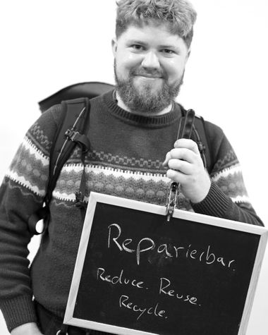 Eine Person aus Oldenburg zeigt ein Schild auf dem steht „Reparierbar. Reduce, Reuse, Recycle“ Foto: Jörg Hemmen