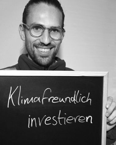 Eine Person aus Oldenburg zeigt ein Schild auf dem steht „Klimafreundlich investieren!“ Foto: Jörg Hemmen