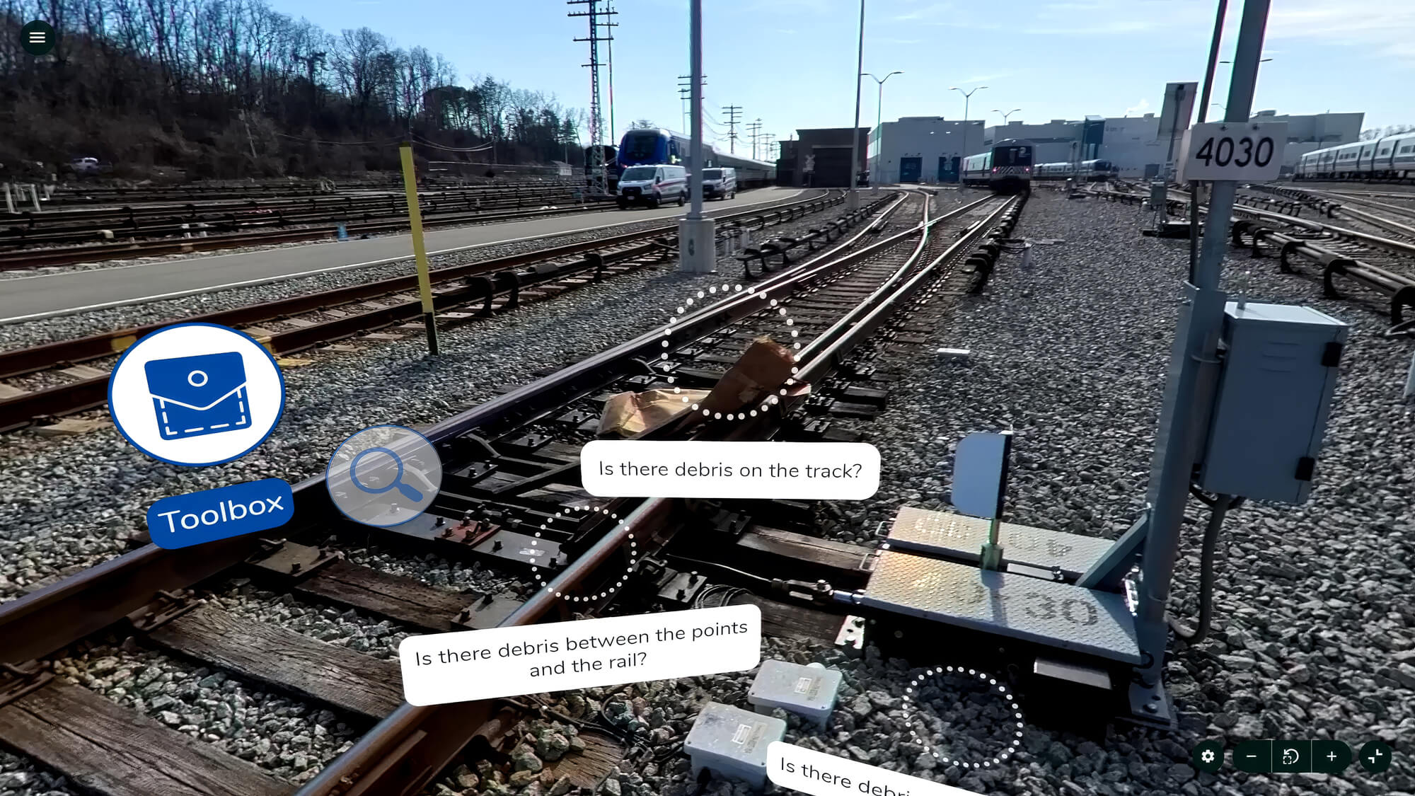 Railway tracks with debris and interactive queries about track safety, including debris on and between rails. A toolbox icon is visible.