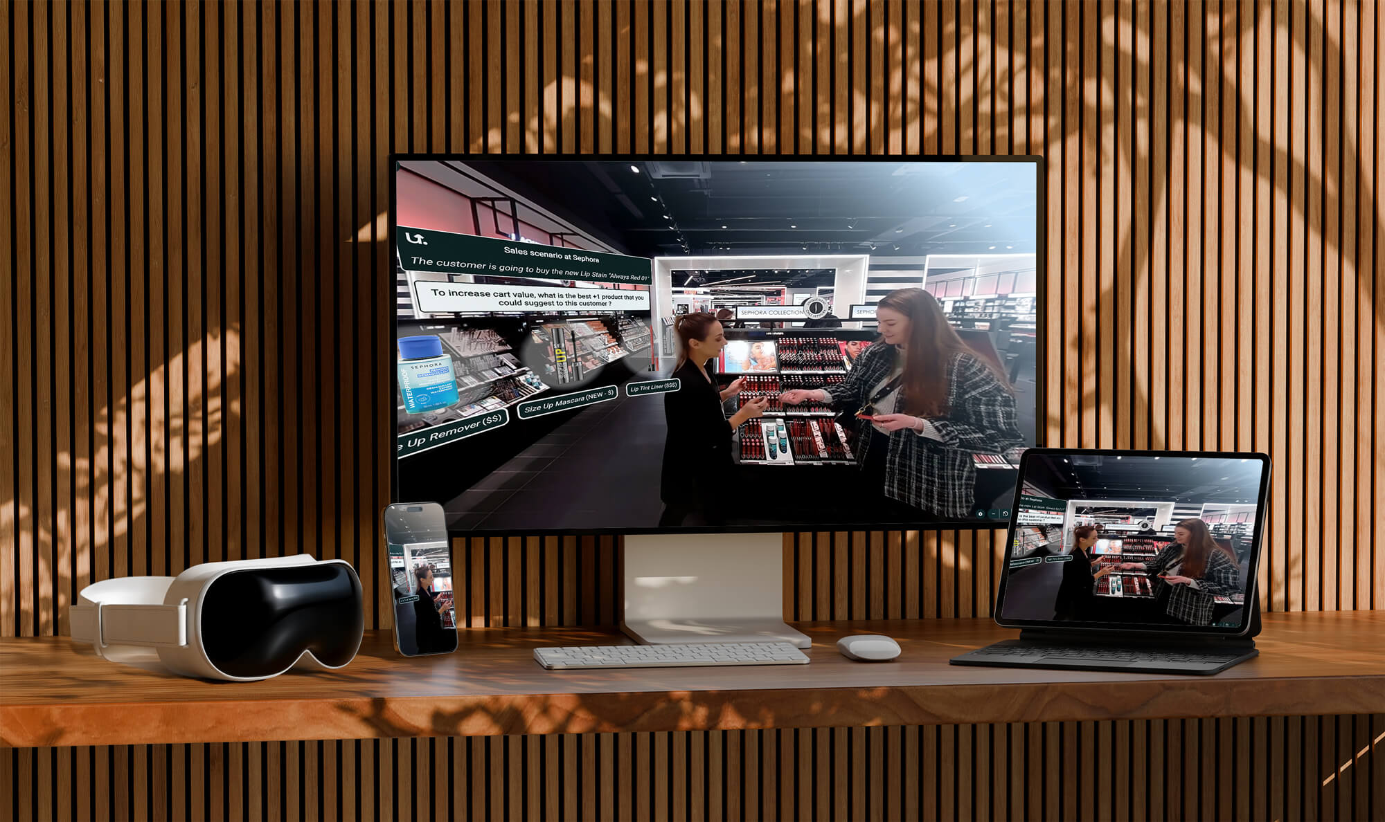 A modern desk setup includes a VR headset, phone, desktop, and laptop showing a sales scenario in a cosmetic store with two women interacting.