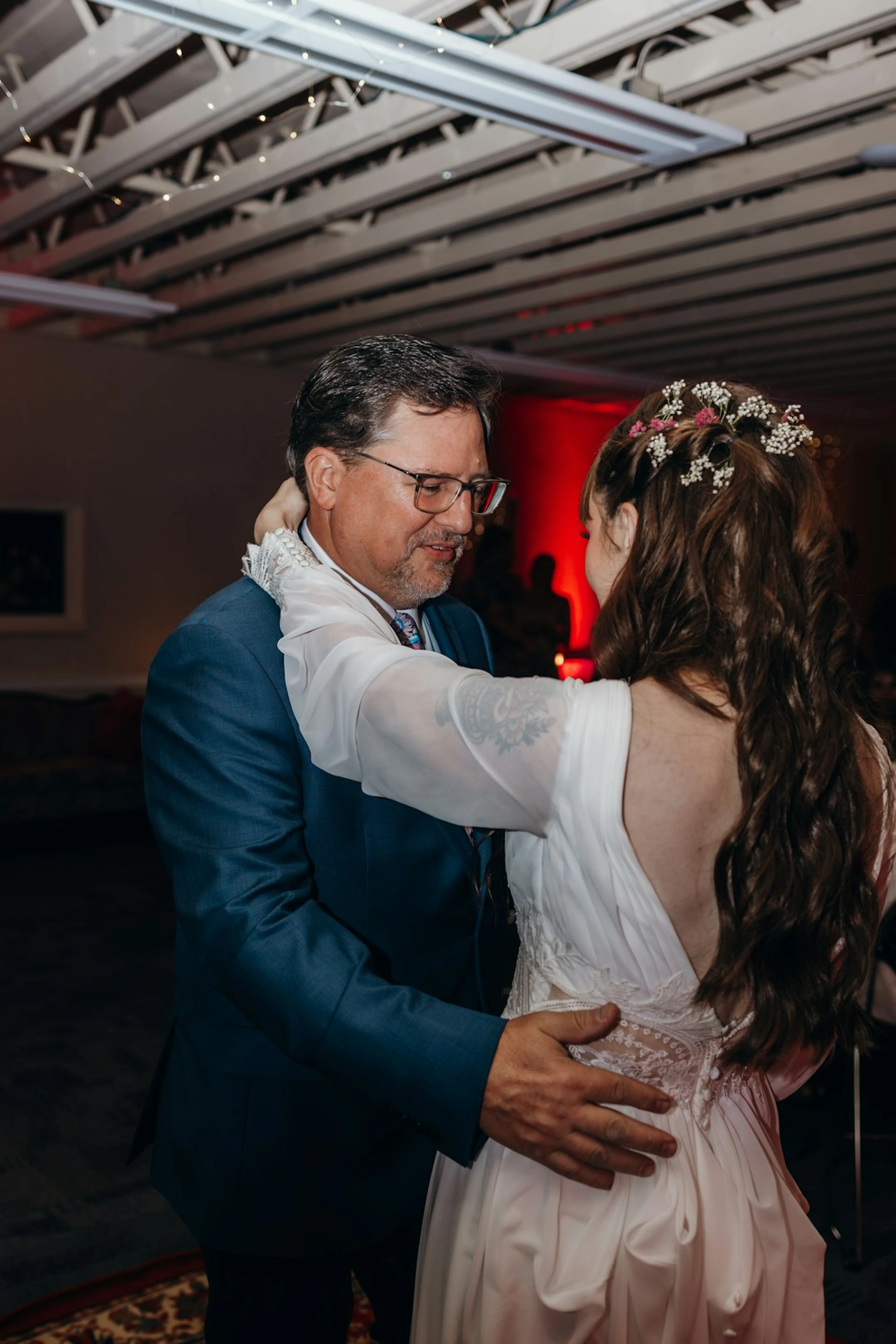 A bride dancing with a guest at her wedding reception