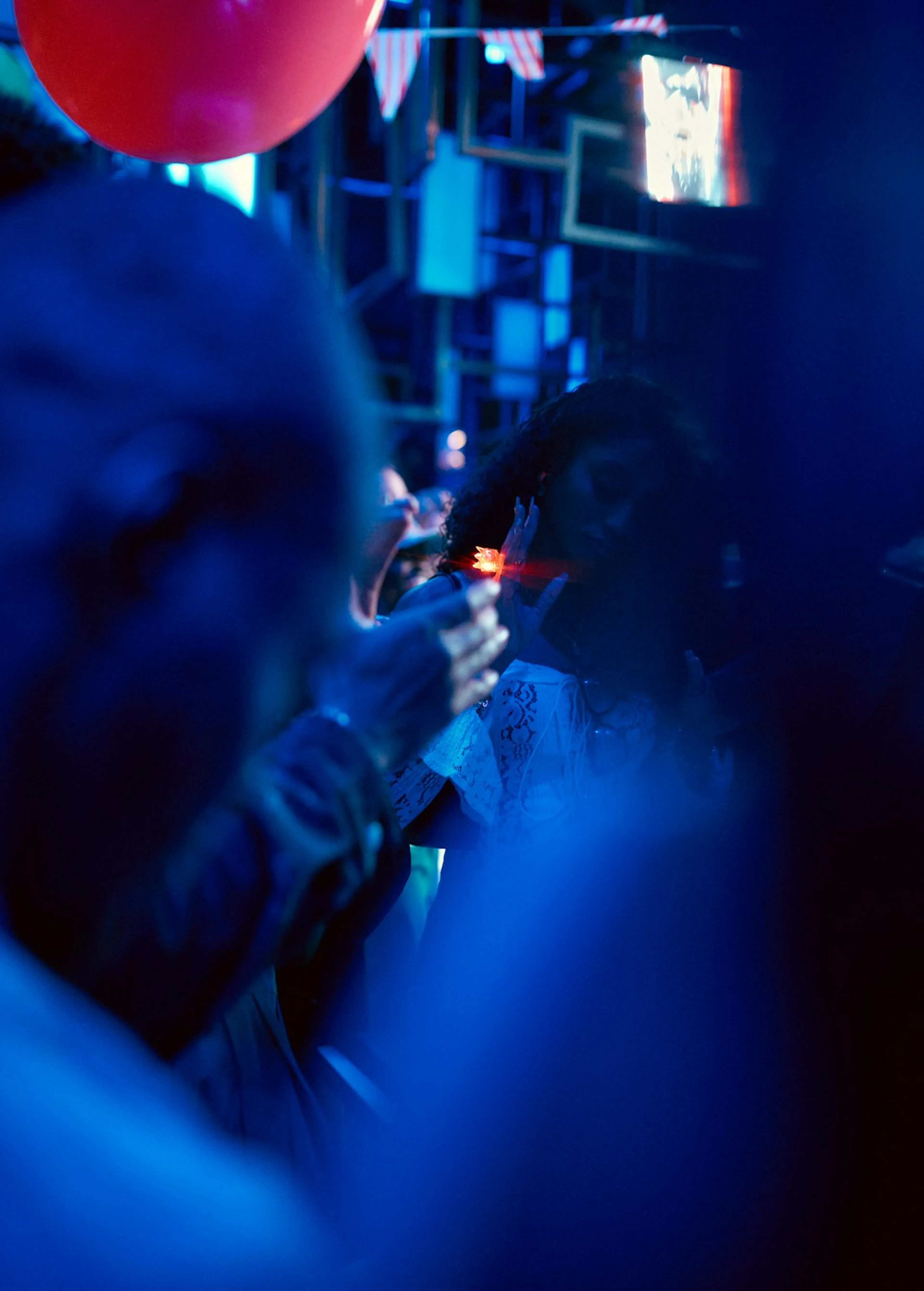 People talking in a dimly lit bar at an evening event