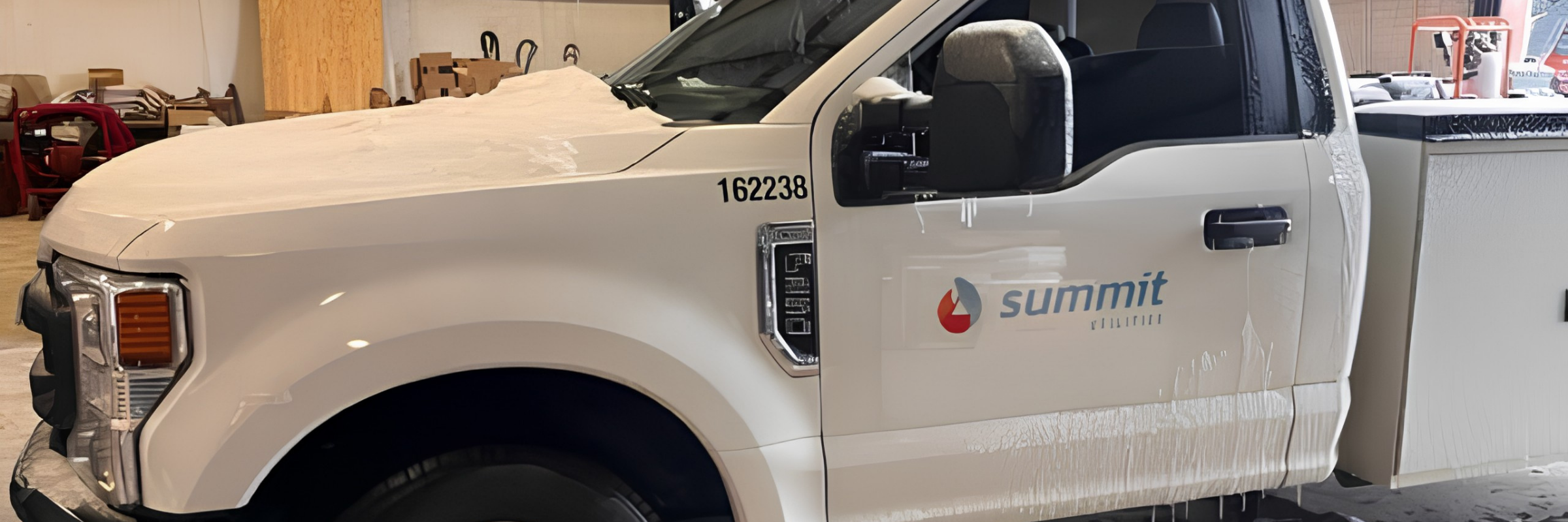 Summit Utilities pickup truck with updated Summit logo and unit number after a fleet rebrand retrofit by Lowen Color Graphics.