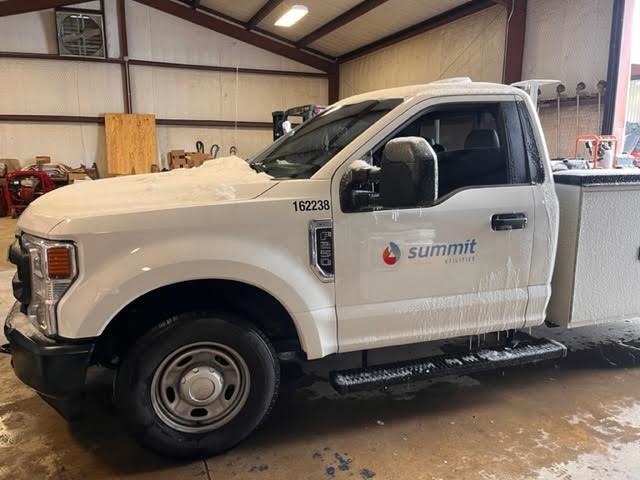 Summit Utilities pickup truck with updated Summit logo and unit number after a fleet rebrand retrofit by Lowen Color Graphics.