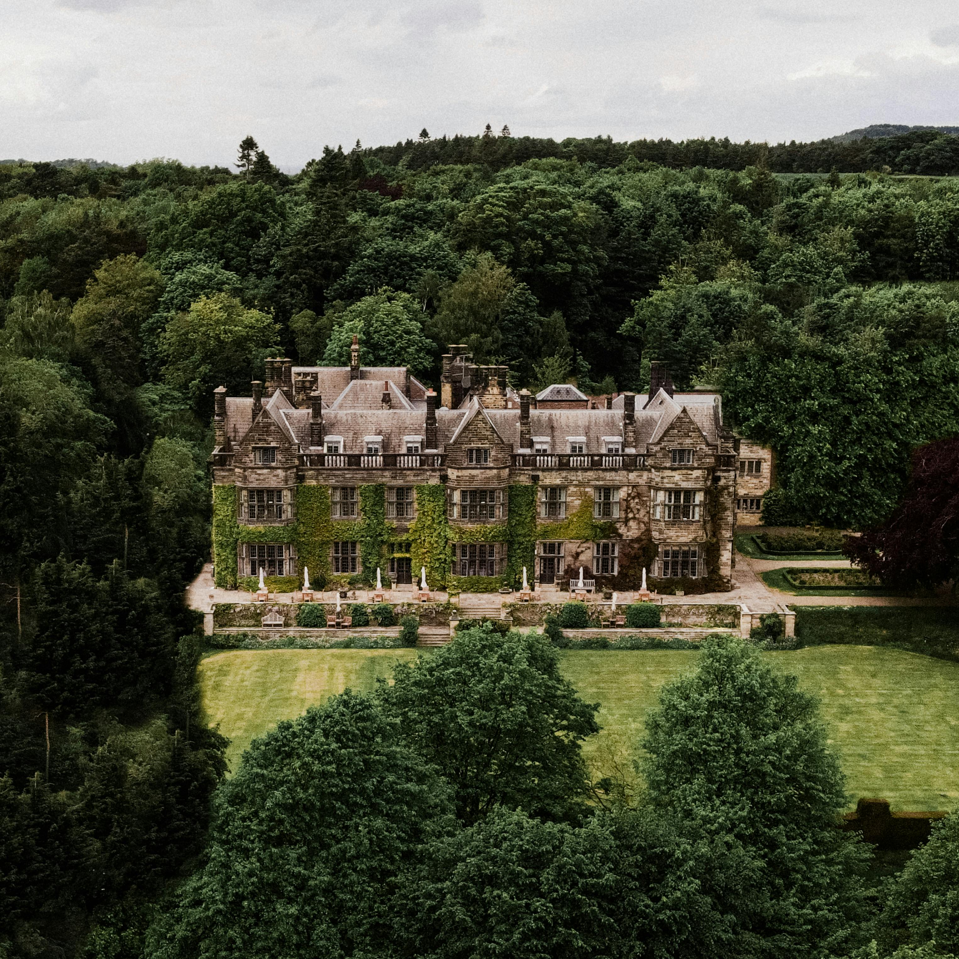A venue team welcoming couples in the grand hall of a wedding estate