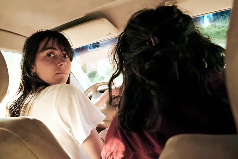 Two woman on car