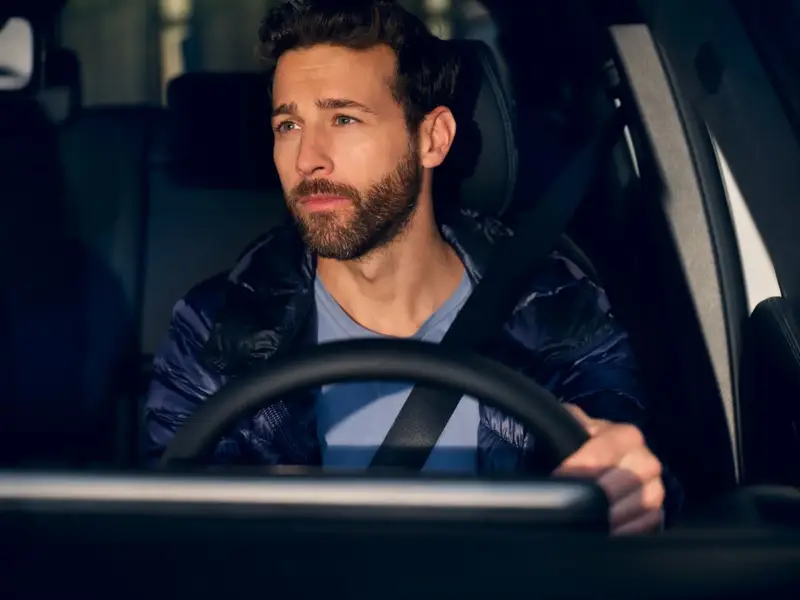 Man driving and looking rear view