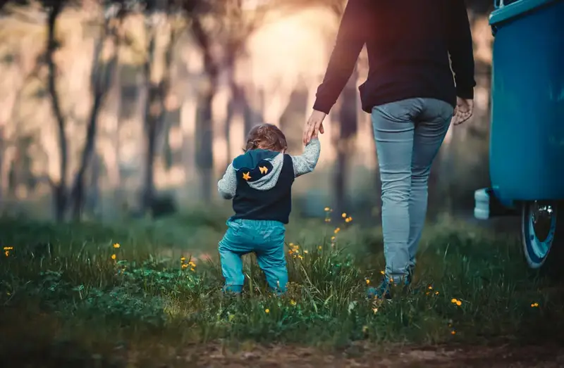 Little child walking with her dad