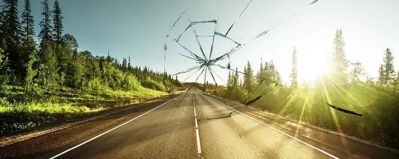 Broken windscreen on road